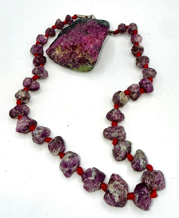 Rough ruby corundum necklace featuring raw, natural gemstone beads from STICS and STONES, displayed on a neutral background.