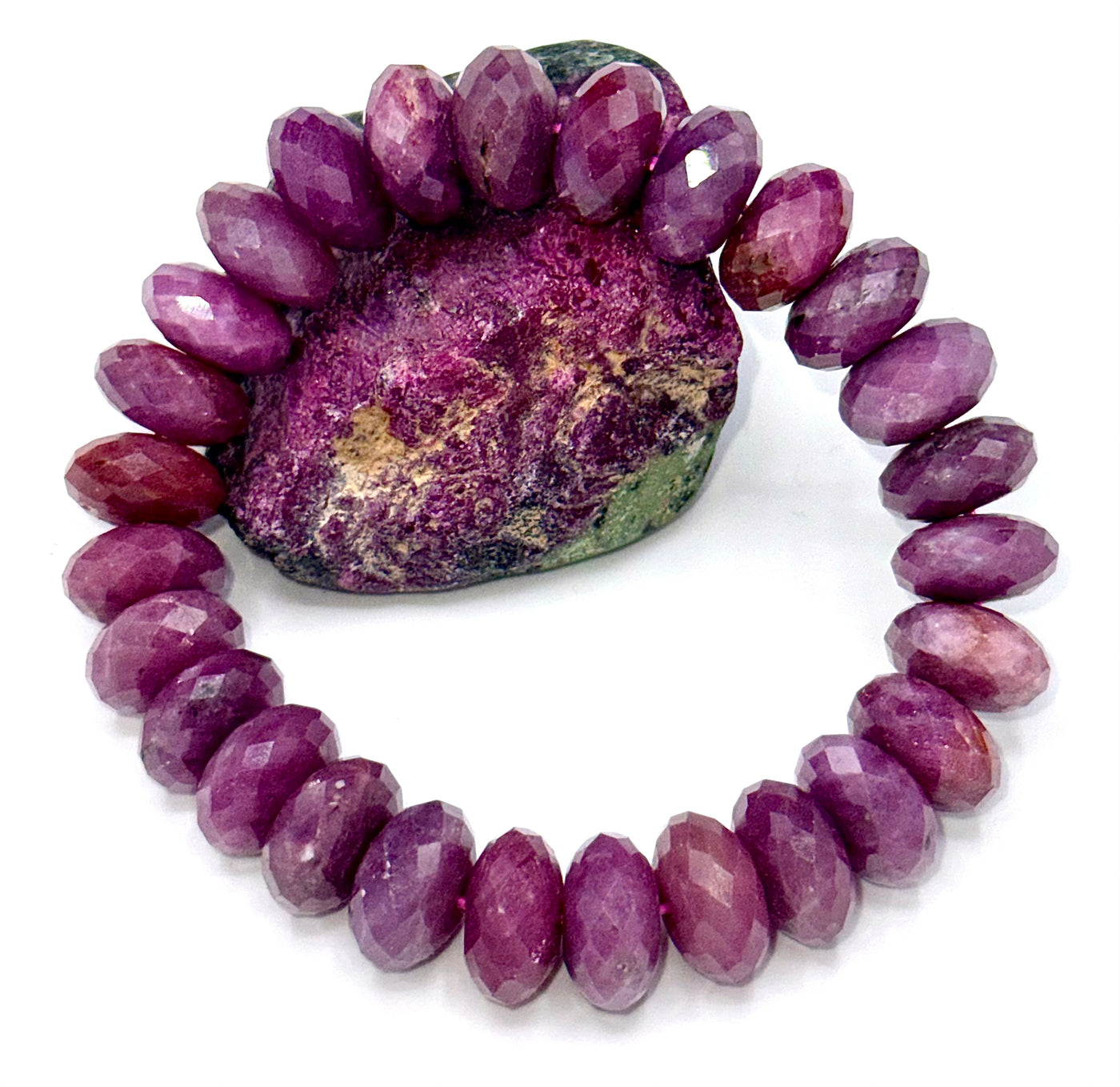 Faceted natural ruby bracelet by STICS and STONES featuring vibrant red gemstones on a delicate silver chain.