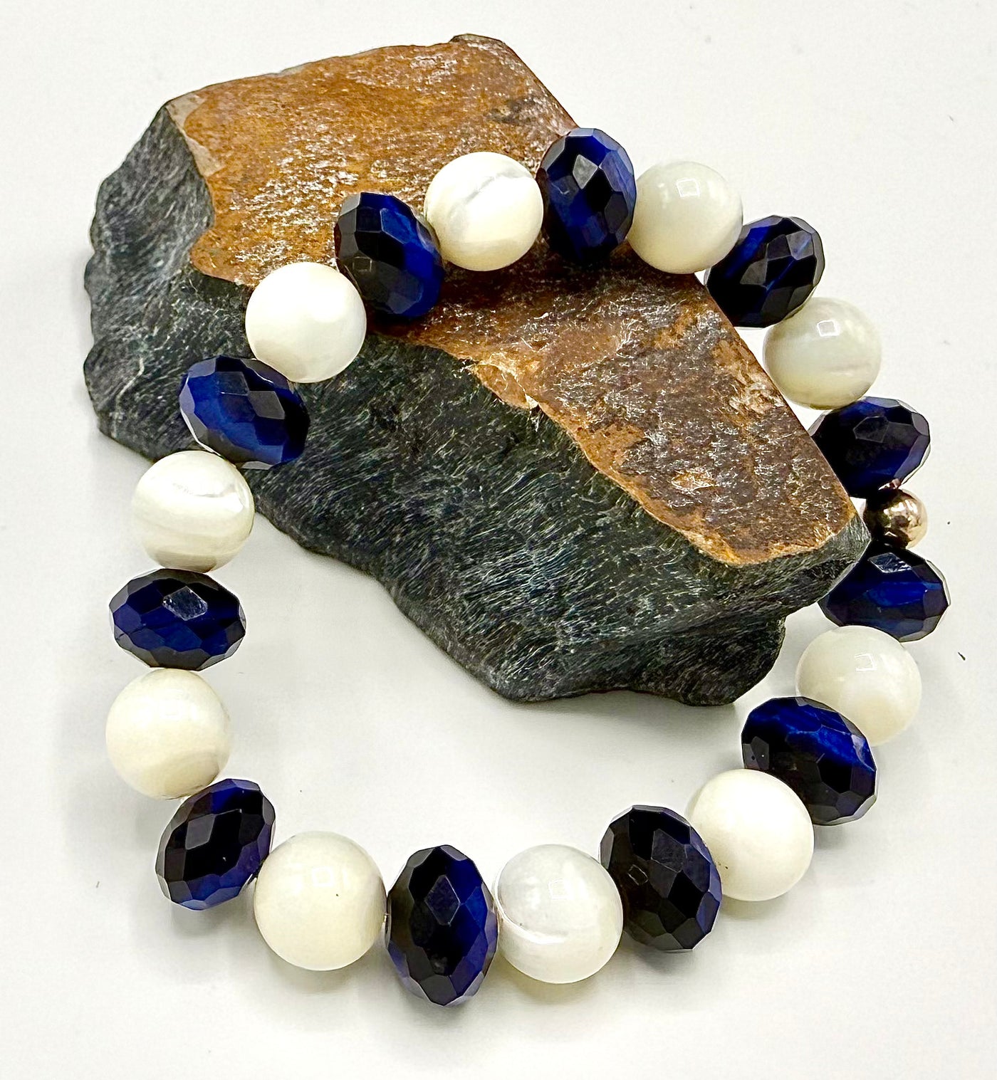 Blue tiger eye bracelet with faceted stones and pearls, dyed, by STICS and STONES. Natural gemstone jewelry for stylish wear.