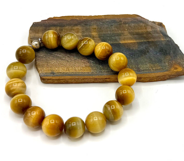 Golden Tiger Eye bracelet featuring polished tiger eye beads on a stretchy cord, stylish accessory by STICS and STONES.