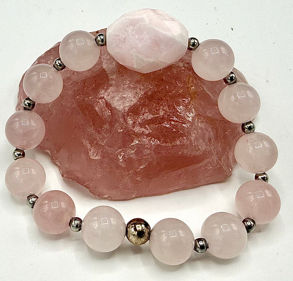 Rose quartz bracelet by STICS and STONES featuring polished pink gemstone beads on an elastic band.