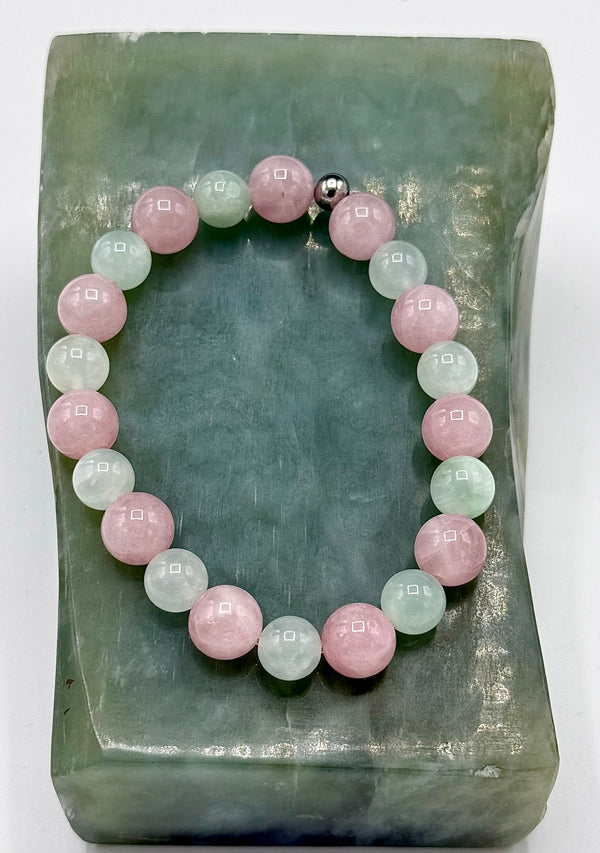 Rose quartz and prehnite bracelet featuring polished beads, designed by STICS and STONES, displayed on a neutral background.