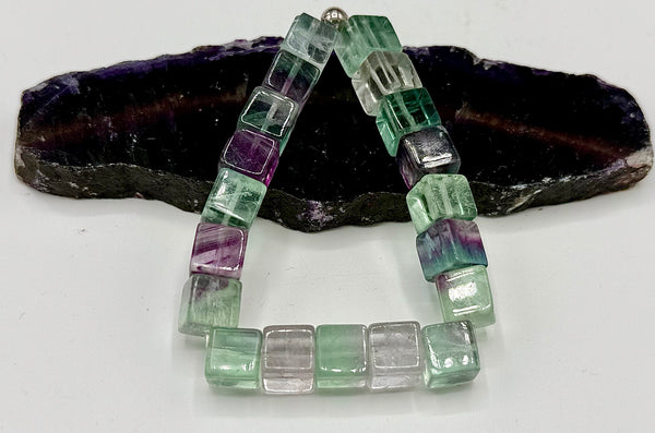 Square fluorite bracelet from STICS and STONES featuring vibrant green and purple stones on a delicate chain.