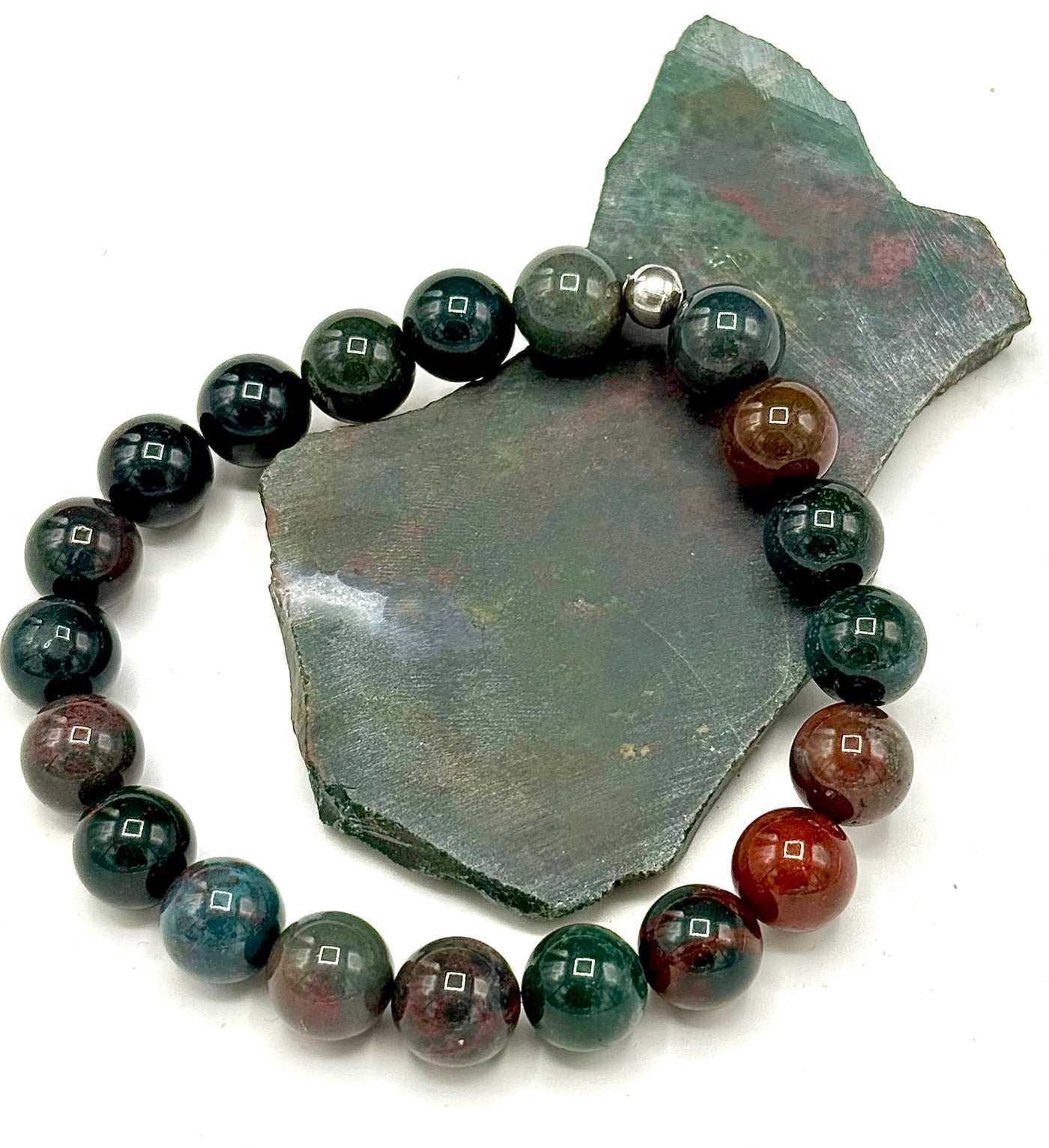 Bloodstone bracelet by STICS and STONES featuring polished round bloodstone beads on an elastic band.