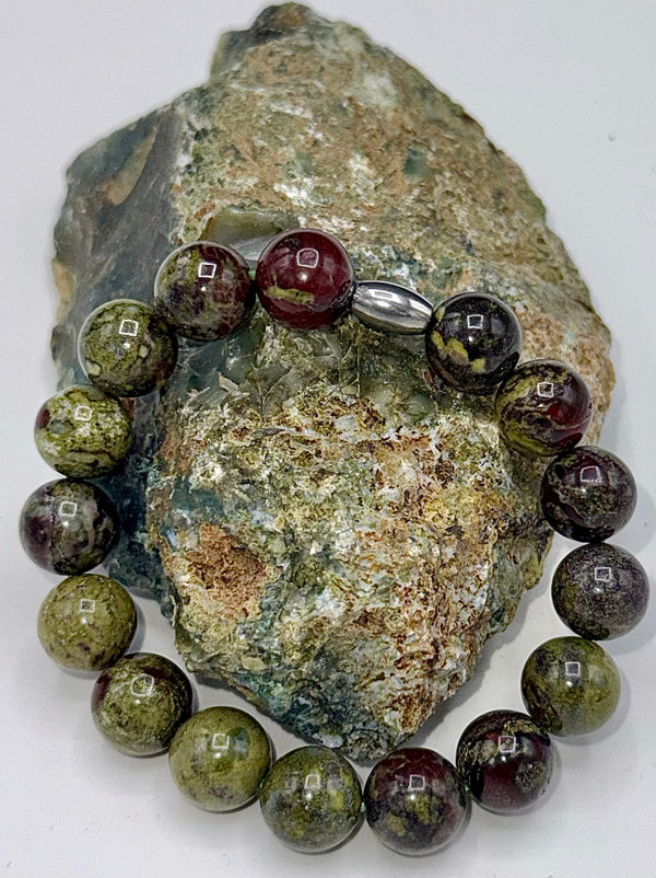 Dragon Bloodstone bracelet by STICS and STONES featuring polished red and green bloodstone beads on an elastic band.