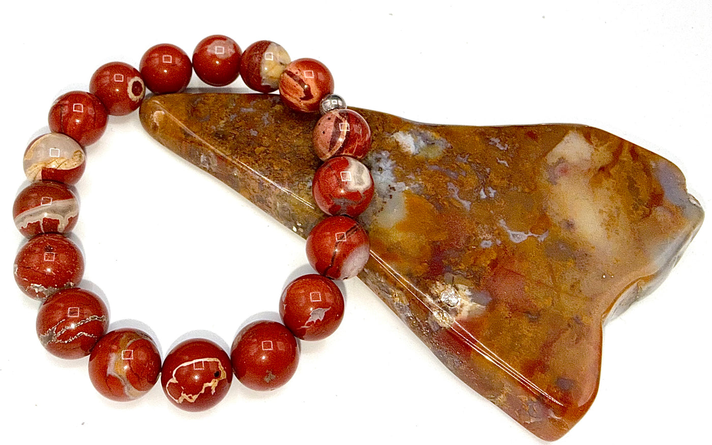 Red Jasper bracelet from STICS and STONES featuring polished gemstone beads on an elastic band.