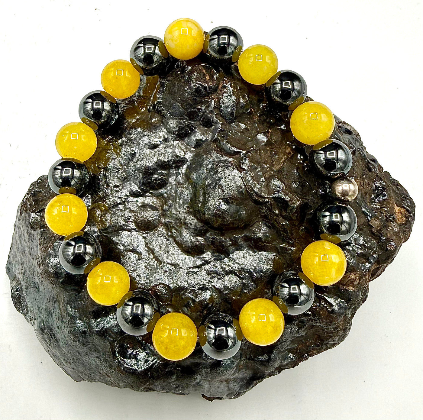 Yellow jade and hematite bracelet by STICS and STONES featuring smooth beads and a stylish, natural gemstone design.