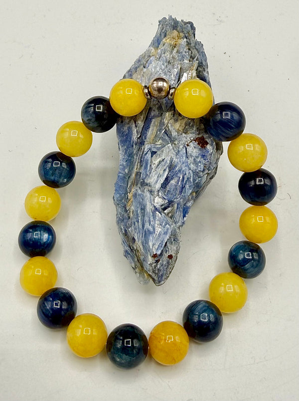 Yellow jade and kyanite bracelet featuring smooth beads from STICS and STONES, styled with a delicate elastic band.