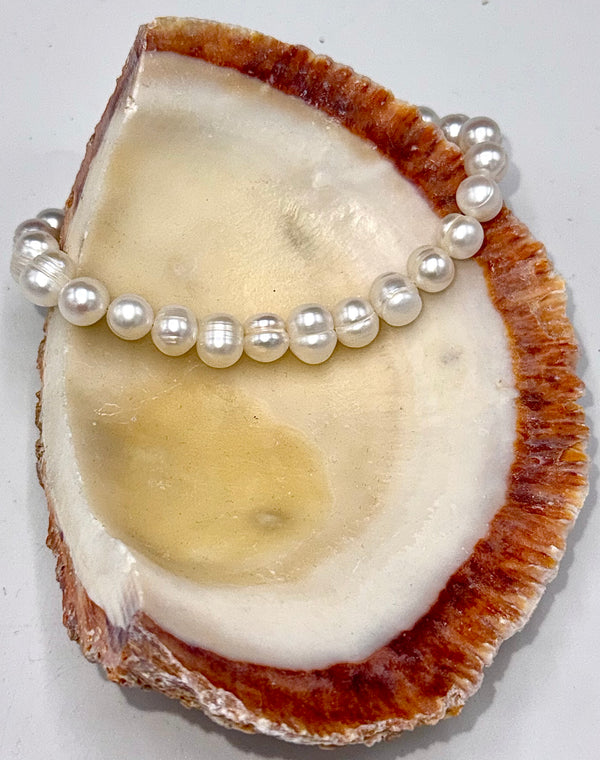 Pearl bracelet with clasp by STICS and STONES, featuring elegant white pearls and a secure metal clasp.