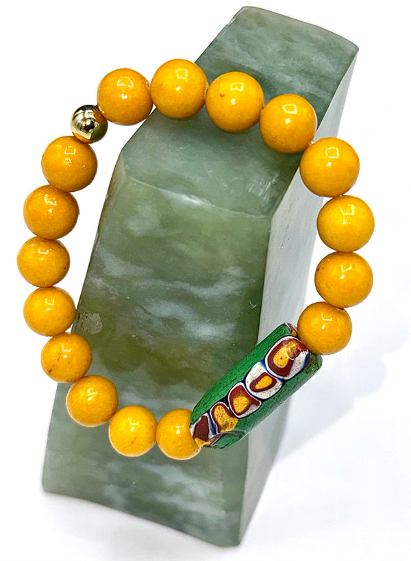 Yellow Jade and old African trade bead bracelet featuring vibrant yellow jade stones and antique trade beads by STICS and STONES.