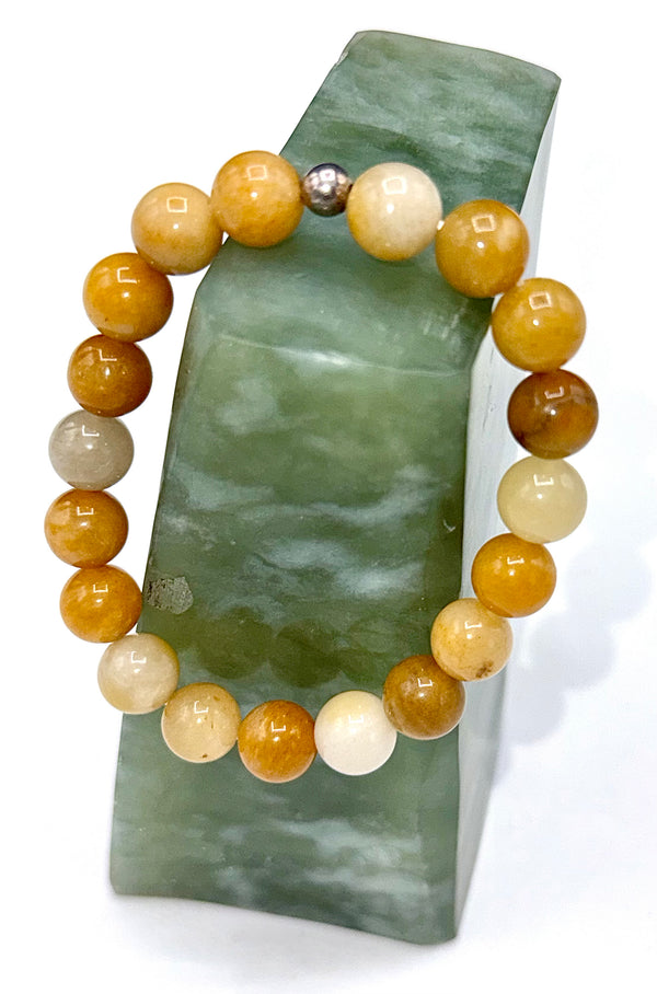 Dark yellow jade bracelet by STICS and STONES featuring polished round jade beads on an elastic band.