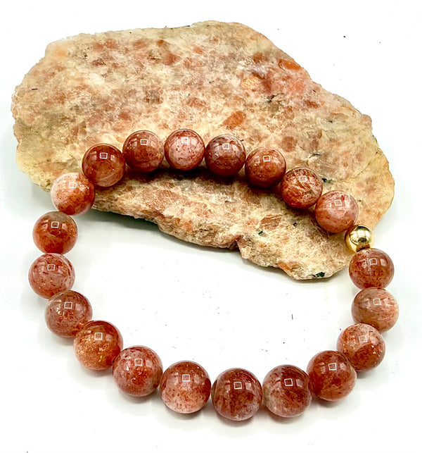 Sunstone bracelet by STICS and STONES featuring polished sunstone beads with a silver clasp, displayed on a neutral background.