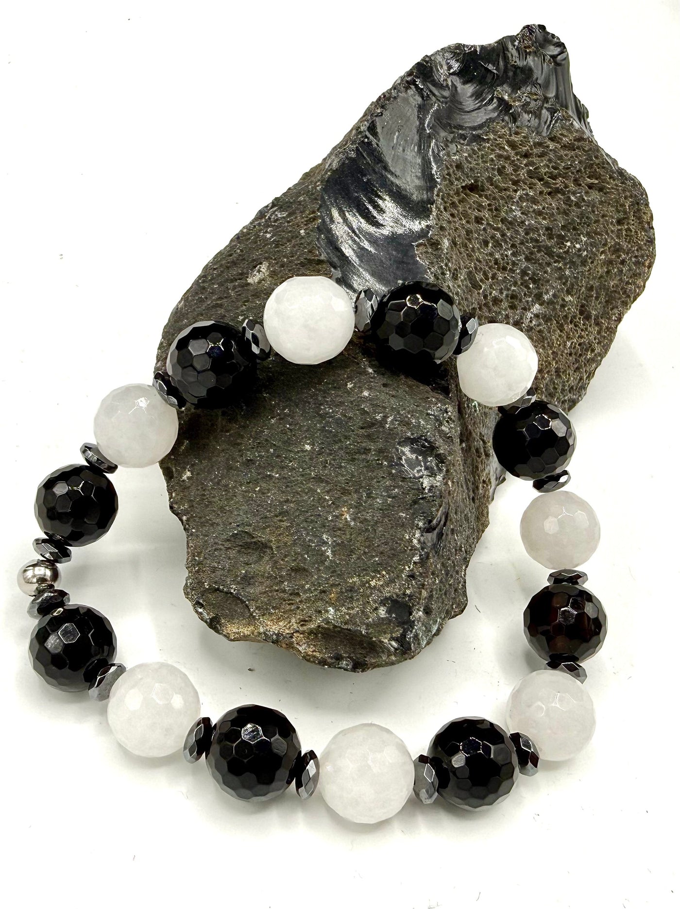 Black and white Onyx bracelet by STICS and STONES featuring smooth, polished beads on an elastic band.