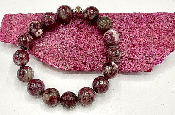 Rubellite and white gemstone bracelet by STICS and STONES featuring vibrant red and clear beads on a delicate string.