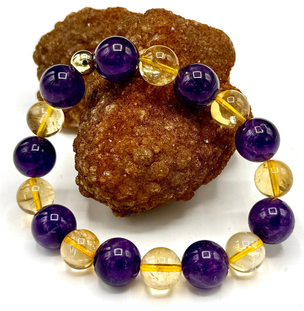 Faceted amethyst and citrine bracelet featuring light purple and yellow gemstones, crafted by STICS and STONES.