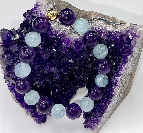Amethyst and Aquamarine bracelet featuring polished gemstone beads on a stretch cord, crafted by STICS and STONES.