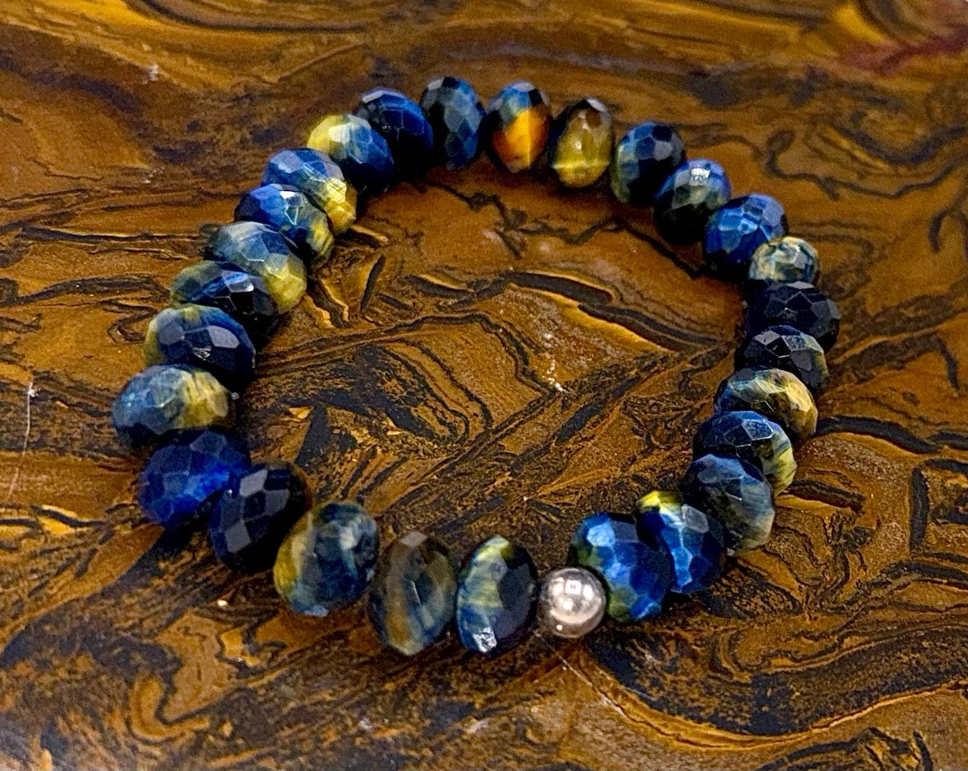 Blue and golden tiger eye bracelet featuring polished stones, crafted by STICS and STONES, displayed on a neutral background.