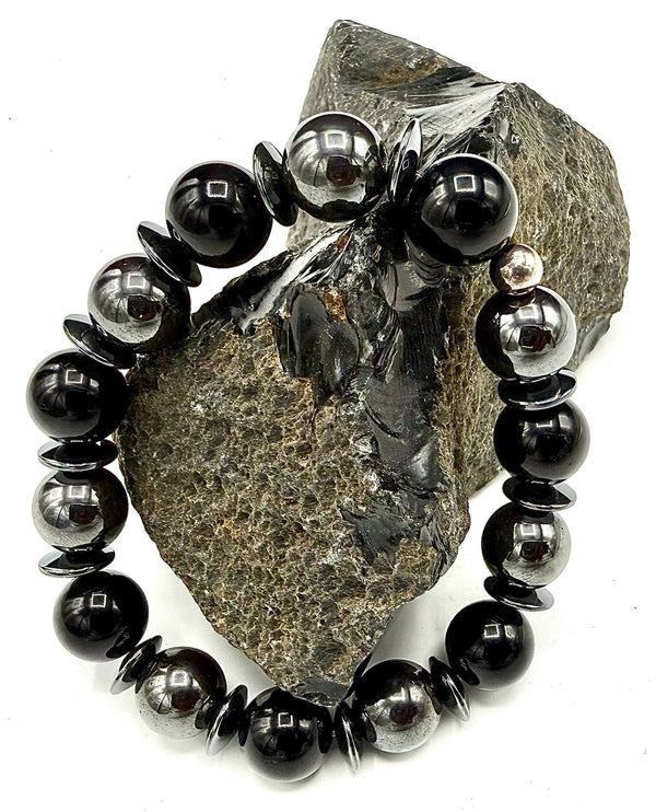 Black Onyx and Hematite round bracelet from STICS and STONES featuring polished beads and an adjustable cord.