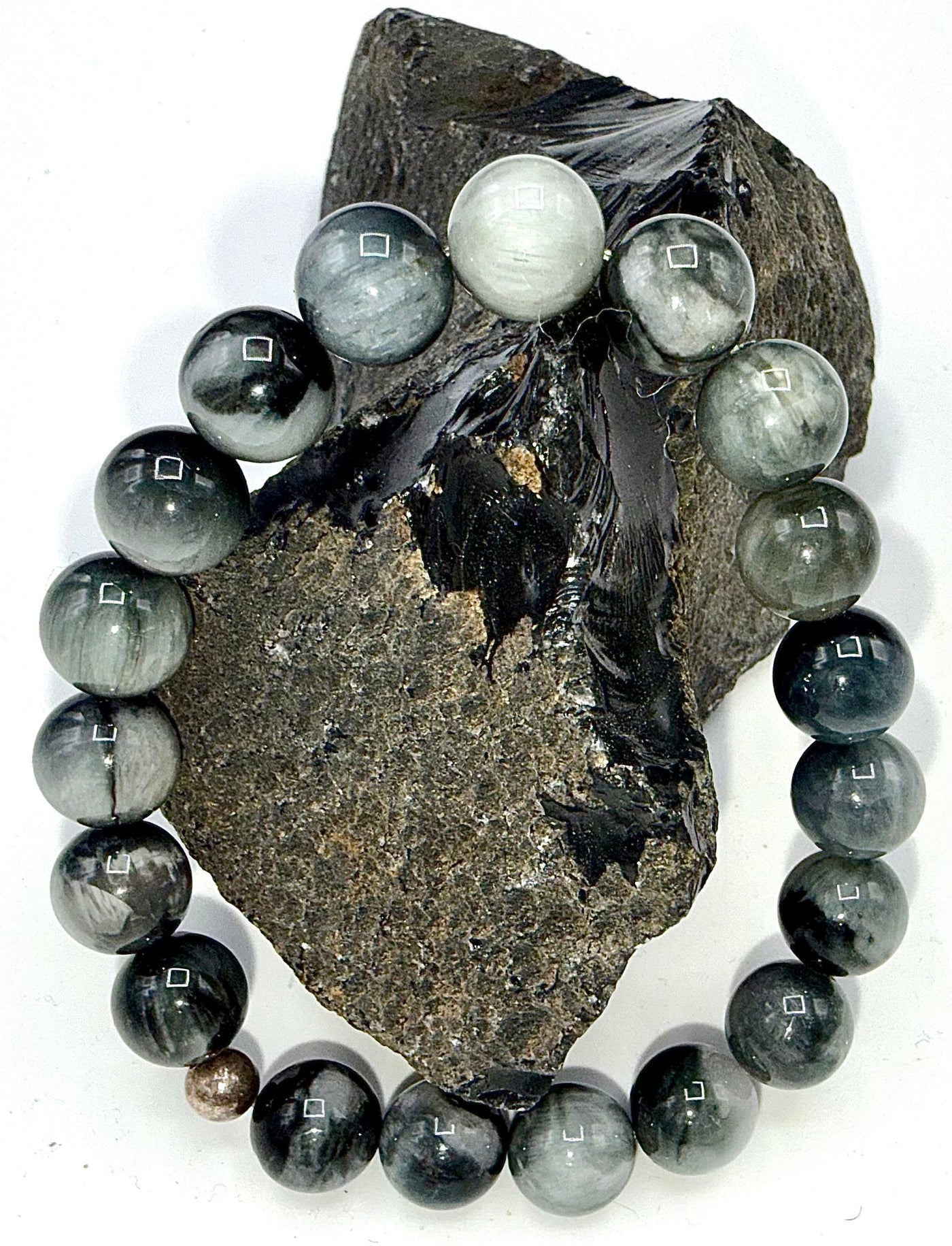 Black and grey jade bracelet from STICS and STONES, featuring smooth round beads on a stretch cord.