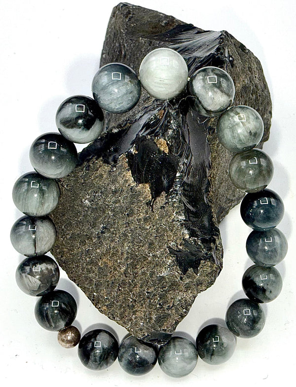 Black and grey jade bracelet from STICS and STONES, featuring smooth round beads on a stretch cord.