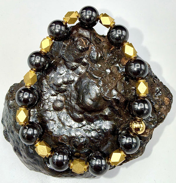 Hematite and brass bracelet with polished beads, featuring a stylish design by STICS and STONES.