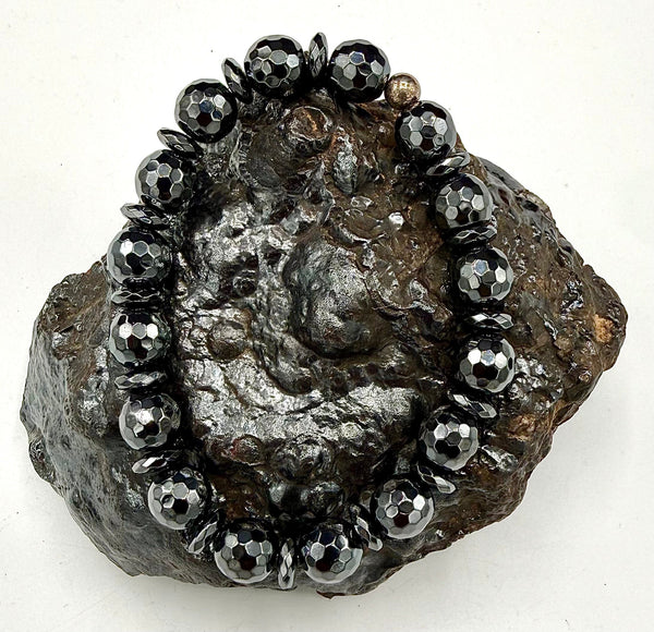 Faceted hematite bracelet from STICS and STONES featuring polished, dark metallic beads on a stretchy band.