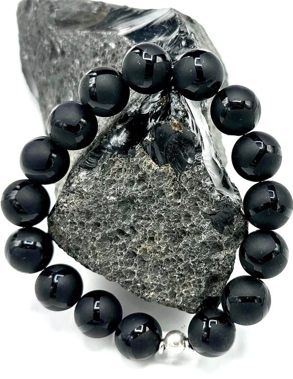 Lava rock bracelet by STICS and STONES featuring black volcanic beads on an elastic band.