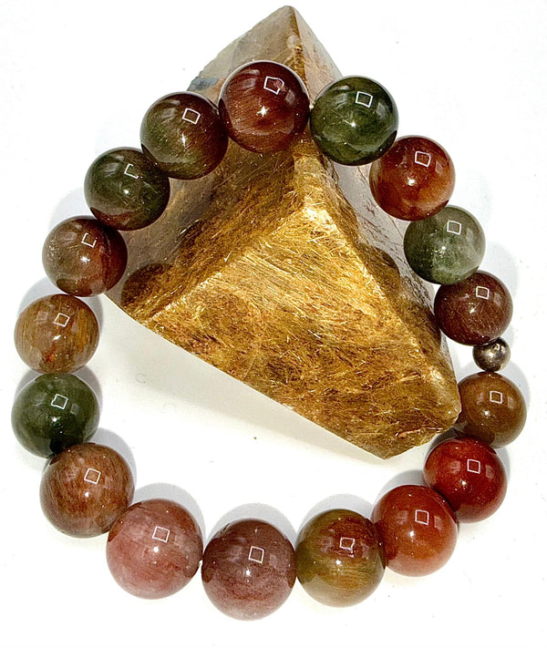 Multicolored rutilated quartz bracelet from STICS and STONES featuring polished gemstone beads on an elastic band.