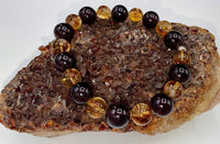 Garnet and citrine beaded bracelet from STICS and STONES featuring vibrant gemstone beads and an elegant adjustable design.