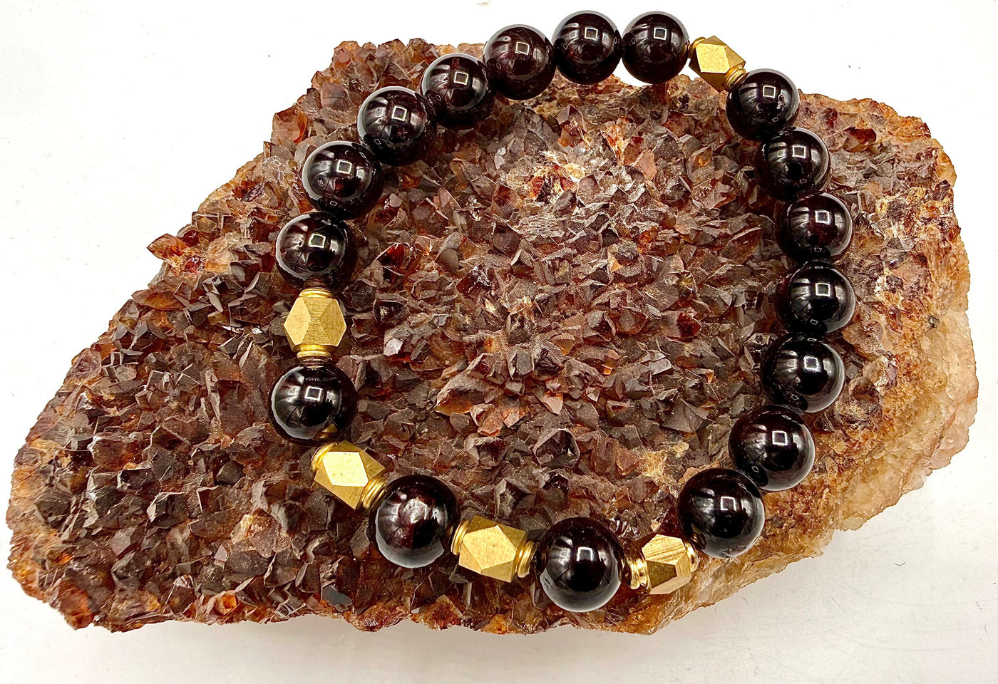 Garnet and brass bracelet with beaded design, featuring polished garnet stones and brass accents, stylish jewelry accessory.
