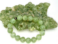Prehnite bracelet featuring smooth green gemstone beads from STICS and STONES, displayed on a neutral background.