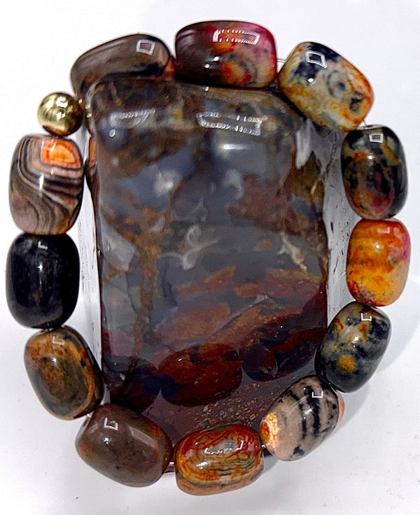 Black, red, and orange agate bracelet by STICS and STONES with smooth polished stones and elastic band design.
