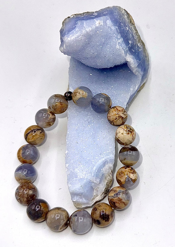 Skinned chalcedony bracelet by STICS and STONES featuring smooth, polished blue gemstone beads on an elastic band.