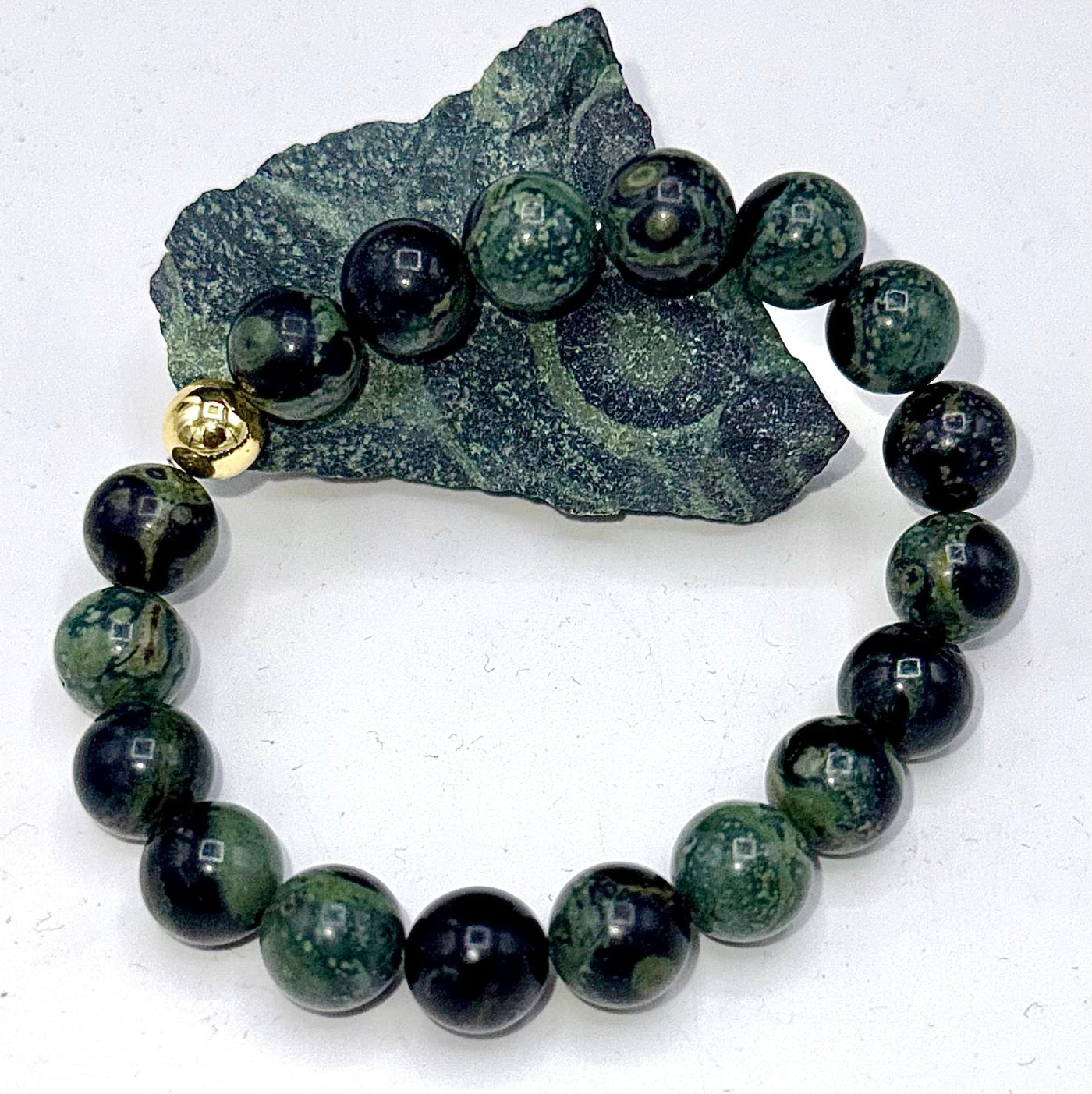 Kambaba Jasper bracelet by STICS and STONES featuring dark green and black patterned stones on an elastic band.