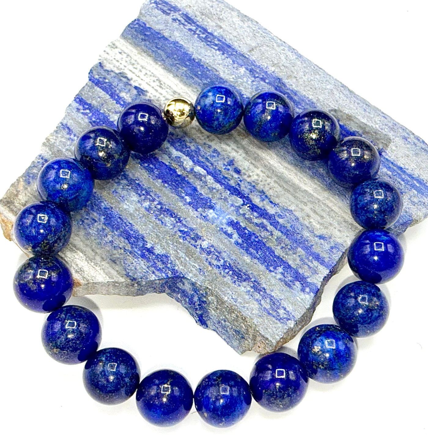 Lapis Lazuli bracelet by STICS and STONES featuring deep blue stones with gold-toned accents, stylish and elegant jewelry accessory.