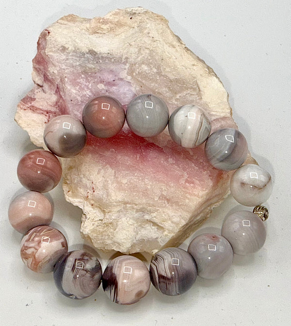 Pink Opal bracelet by STICS and STONES featuring smooth, polished pink opal beads on an elastic cord.