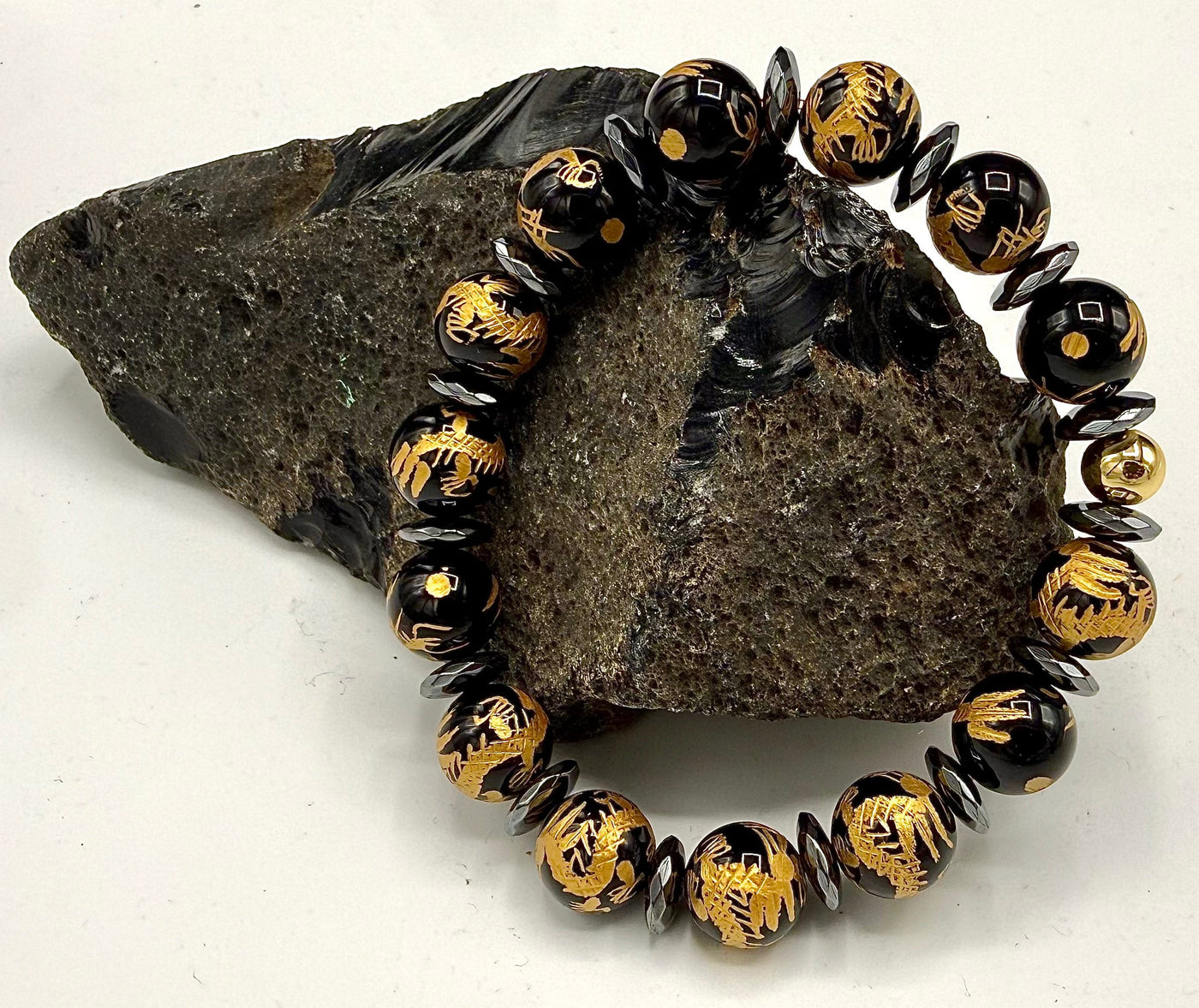 Black Onyx bracelet with intricate gold carving, featuring a stylish design from STICS and STONES.
