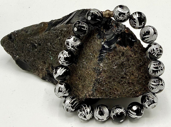 Black Onyx bracelet with intricate silver carving, featuring polished stones and detailed metalwork from STICS and STONES.
