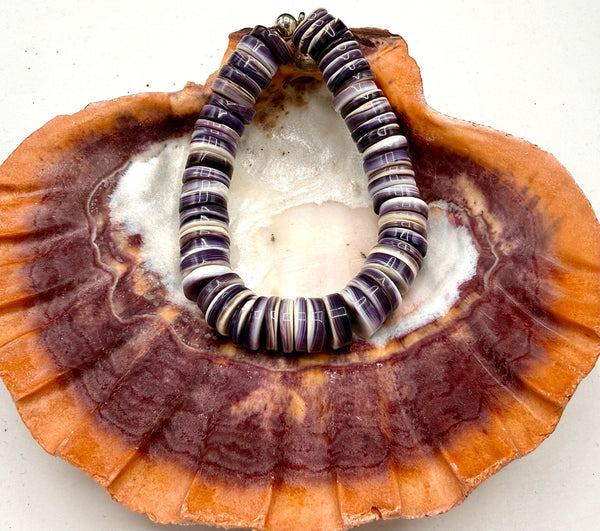 Wampum bracelet by STICS and STONES with polished shell beads and intricate design on a neutral background.