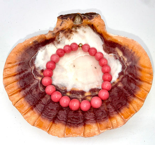 Natural coral bracelet by STICS and STONES featuring vibrant coral beads on a stylish bracelet design.