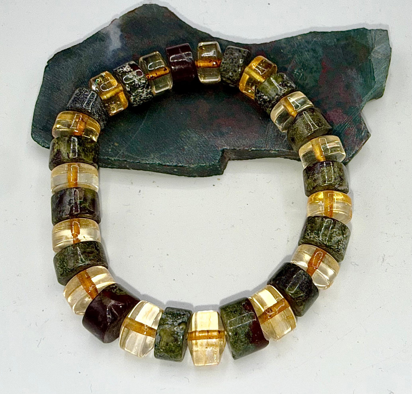 Bloodstone and citrine bracelet featuring natural gemstone beads from STICS and STONES, displayed on a neutral background.