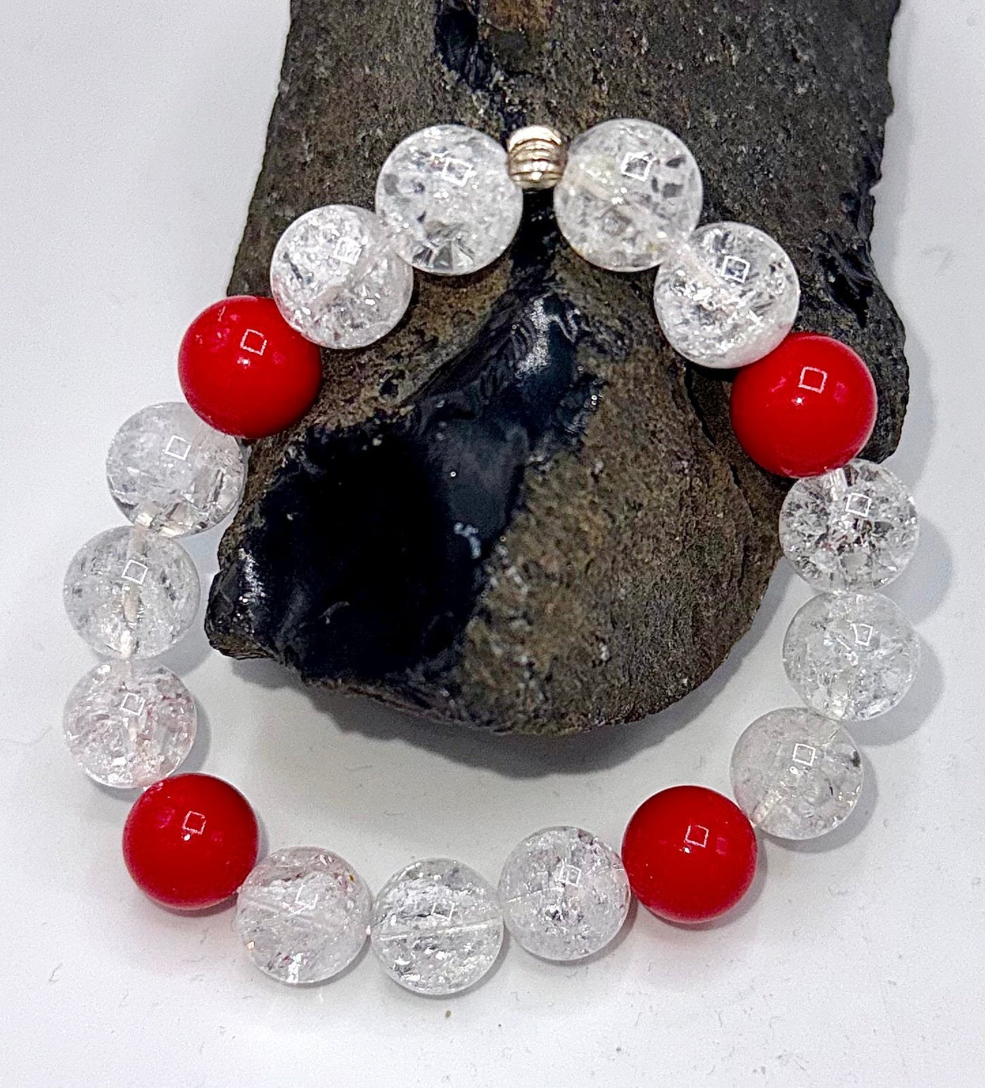 Red and white cracked quartz bracelet by STICS and STONES featuring vibrant gemstone beads and a stylish design.