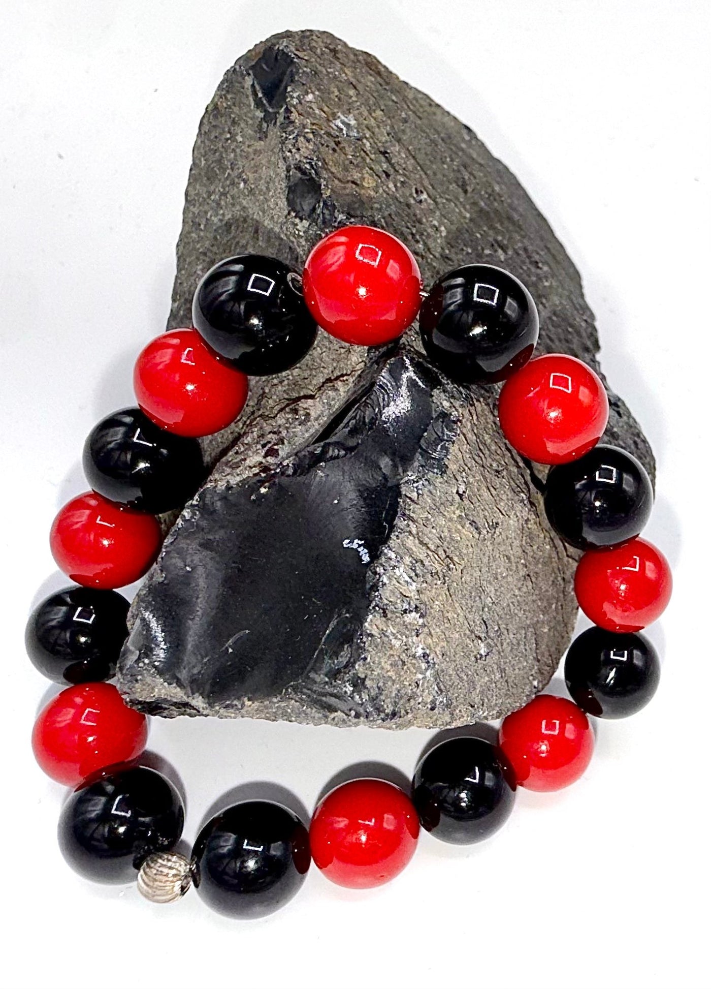 Onyx and red pearl bracelet featuring black onyx beads and vibrant red pearls, stylish jewelry accessory by STICS and STONES.