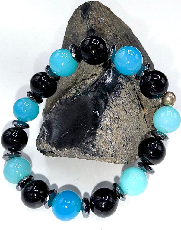 Blue Chalcedony and Onyx bracelet featuring polished beads from STICS and STONES, displayed on a neutral background.