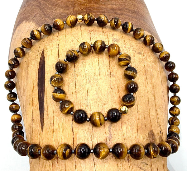Brown Tiger Eye jewelry set with necklace and bracelet from STICS and STONES, featuring polished tiger eye stones and gold-tone accents.