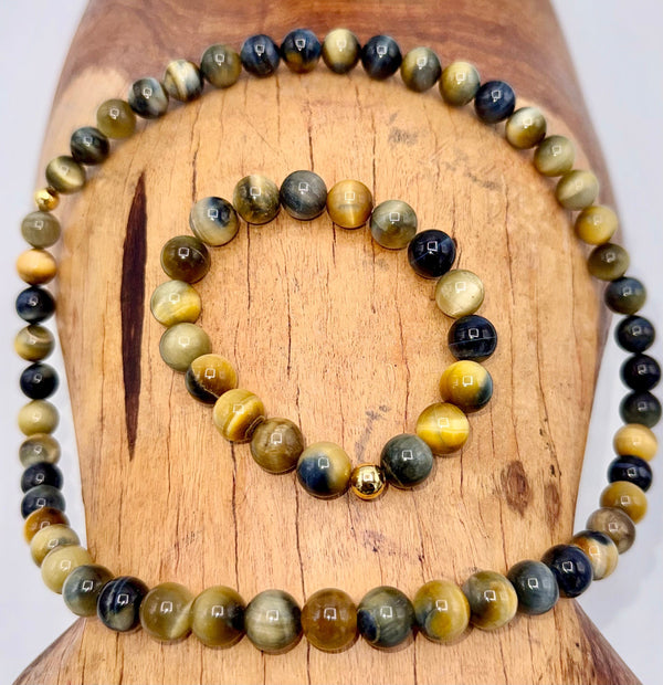 Black, grey, and gold tiger eye bracelet set from STICS and STONES, featuring polished stone beads and elastic stretch design.