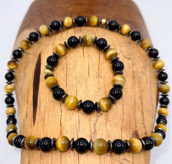 Black Onyx and Golden Tiger Eye jewelry set featuring a necklace and bracelet from STICS and STONES, with polished stone beads.