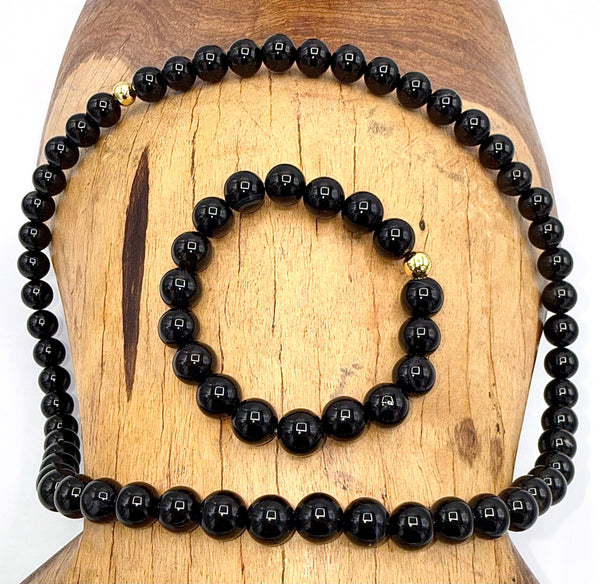 Black Onyx jewelry set including necklace and bracelet from STICS and STONES, featuring polished black onyx stones and silver accents.