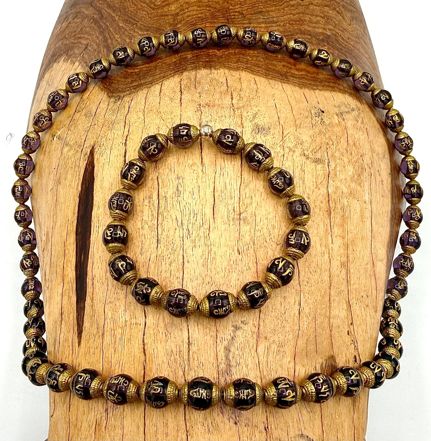 Amethyst prayer carved necklace and bracelet jewelry set featuring purple gemstone beads and intricate carved designs.