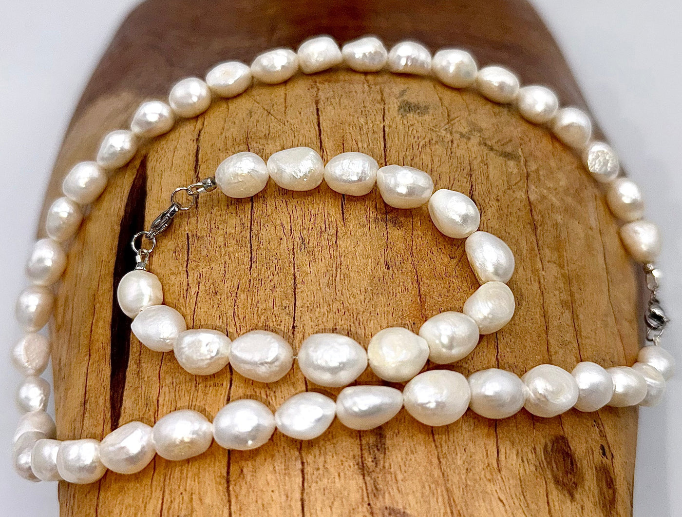 Smaller pearl necklace and bracelet jewelry set by STICS and STONES featuring elegant white pearls on a delicate chain and bracelet.